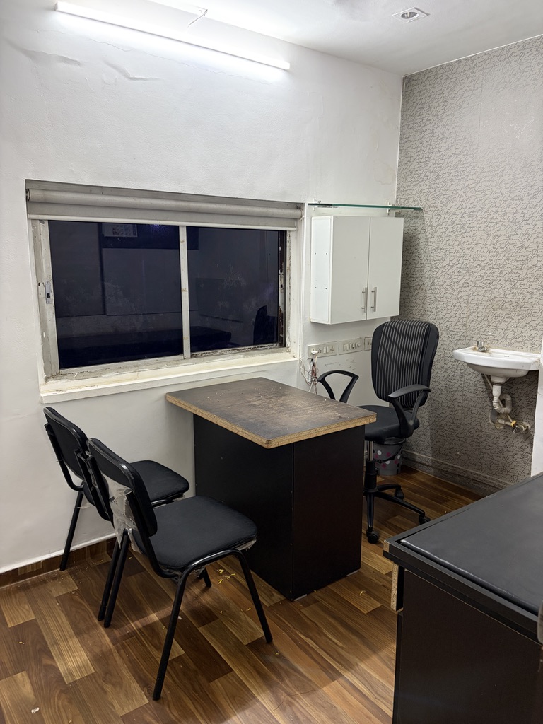 Consultation room with desk and chairs at Shree Vishwamorya Ayurveda and Panchakarma Clinic